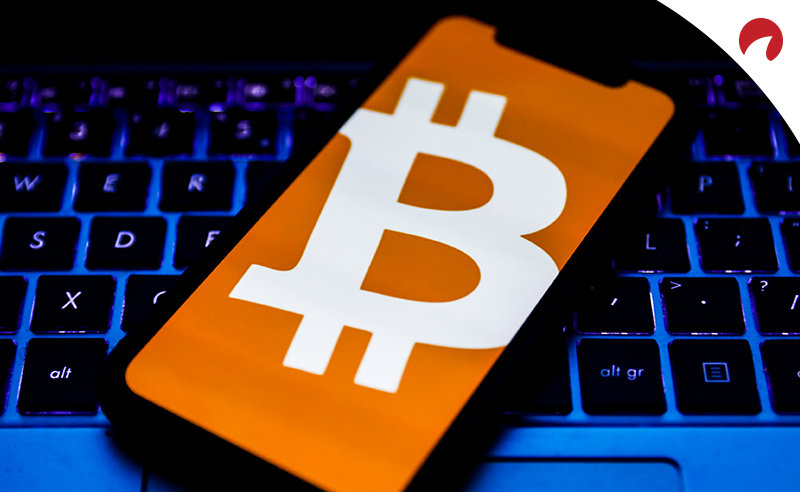 bitcoin icon on a mobile phone placed on a laptop